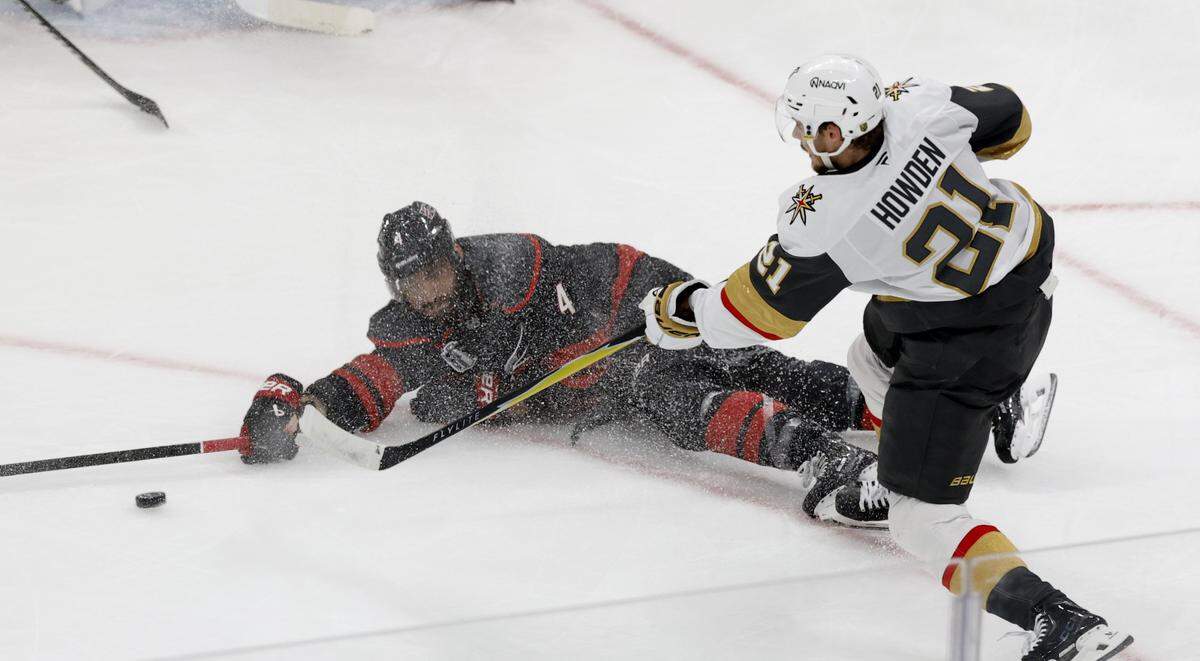 Carolina's Shayne Gostisbehere (4) tries to block the pass by Vegas’ Brett Howden (21) in the first period of the Hurricanes’ game against the Golden Knights in the first game of the Stanley Cup Final at the Lenovo Center in Raleigh, N.C., Tuesday, June 2, 2026.