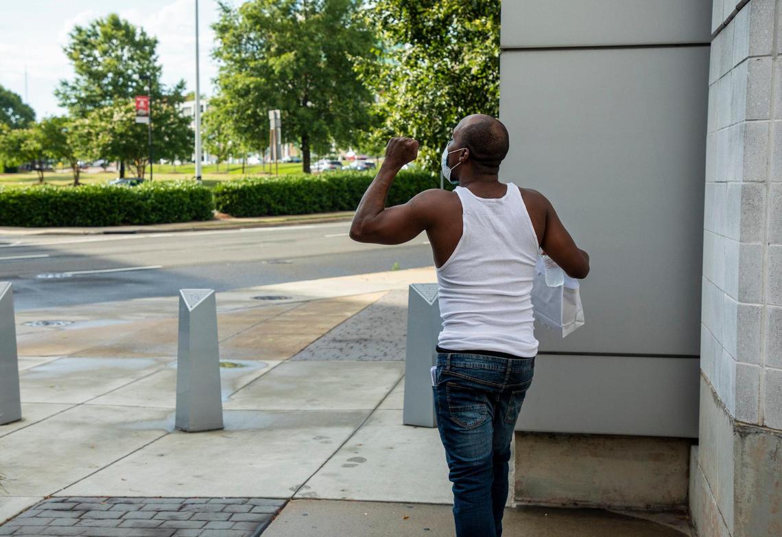Mark Ellis raises a fist to the air after leaving the Durham County Detention Center with 26 other men who were bailed out by AndrŽa ÒMuffinÓ Hudson, director of the NC Community Bail Fund of Durham, with $100,000 in cash as a celebration of Juneteenth and in time for them to spend FatherÕs Day at home while they await their trials, on Friday Jun. 19, 2020, at the Durham County Detention Facility, in Durham, N.C. Nineteen men were freed before the magistrate ran out of receipts around 6pm so Hudson plans to return the following day to complete the rest.