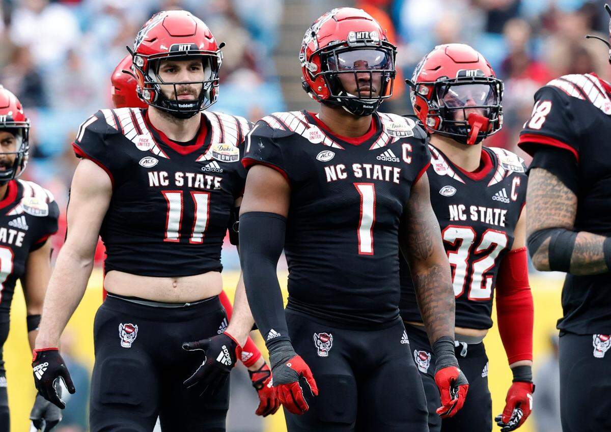 N.C. State linebackers Payton Wilson (11), Isaiah Moore (1) and Drake Thomas (32) line up during the second half of Maryland’s 16-12 victory over the Wolfpack in the Duke’s Mayo Bowl at Bank of America Stadium in Charlotte, N.C., Friday, Dec. 30, 2022.