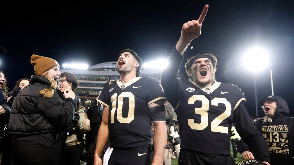 Wake Forest quarterback Sam Hartman (10) and wide receiver Jarrett Brown (32) celebrate after Wake Forest’s 45-42 victory over N.C. State at Truist Field in Winston-Salem, N.C., Saturday, November 13, 2021.