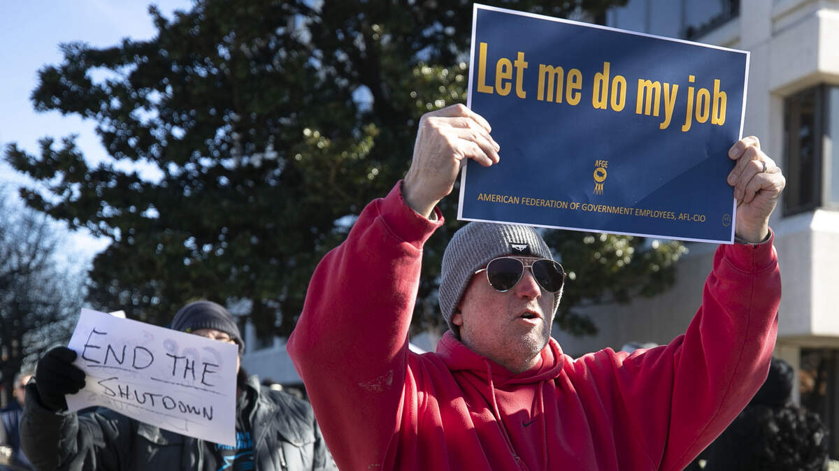Mike Jones of Cary, N.C. an EPA employee, marches with nearly a hundred other protestors outside the Federal Building on New Bern Avenue urging Sen.Thom Tillis and Sen.Richard Burr to end the government shutdown.