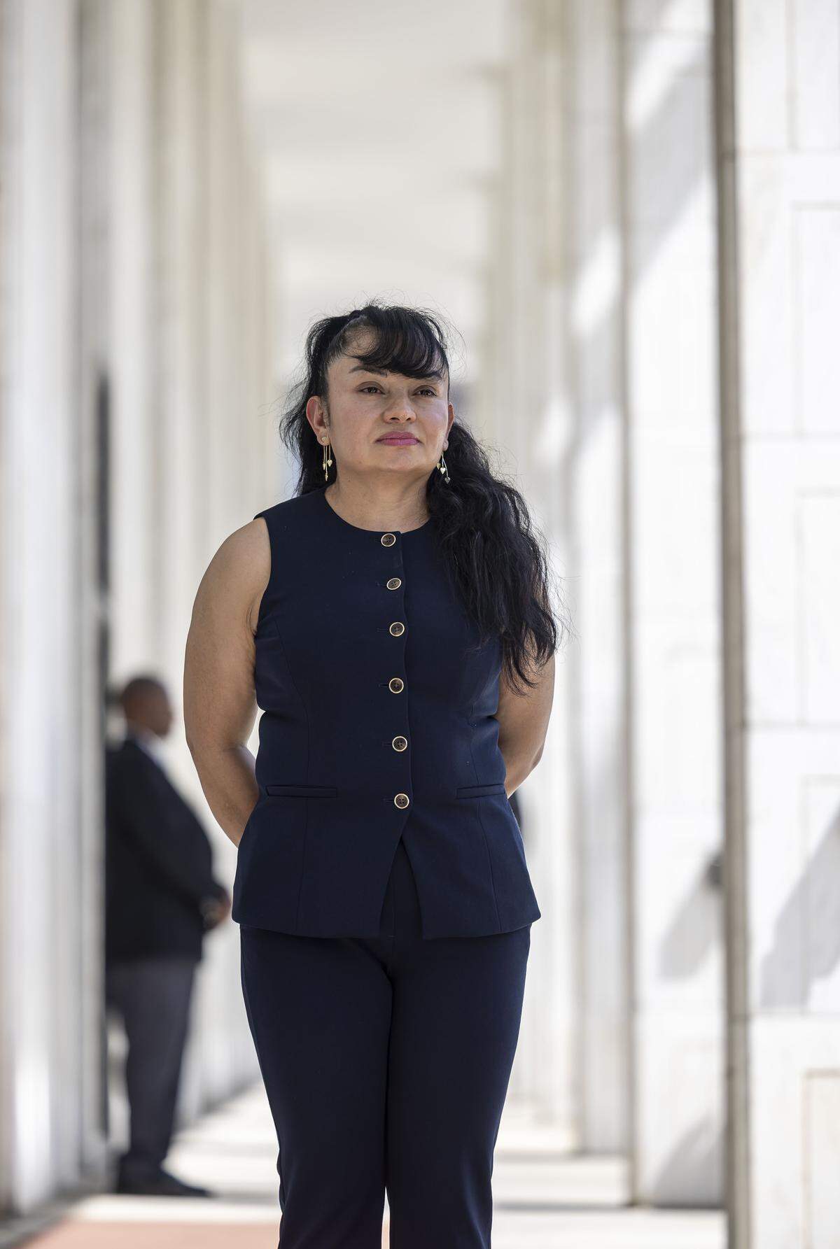 Former Duke employee Margoth Erazo, stands beneath the columns of the North Carolina General Assembly on Wednesday, awaiting her opportunity to speak on Temporary Protected Status.