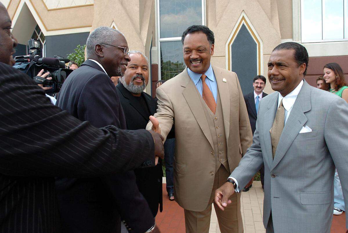 Rev. Jesse Jackson (center) greets supporters outside of the United House of Prayer for All People on Beatties Ford Road, prior to the Charlotte-Mecklenburg County branch of the NAACP-sponsored "Taking Souls to the Polls" voting rally on Sunday, August 8, 2004.