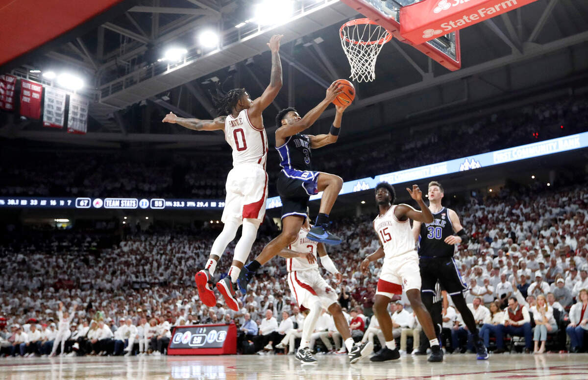 Duke’s Jeremy Roach (3) heads to the basket while defended by Arkansas’ Khalif Battle (0) during Arkansas’ 80-75 victory over Duke at Bud Walton Arena in Fayetteville, Ark., Weds. Nov. 29, 2023.
