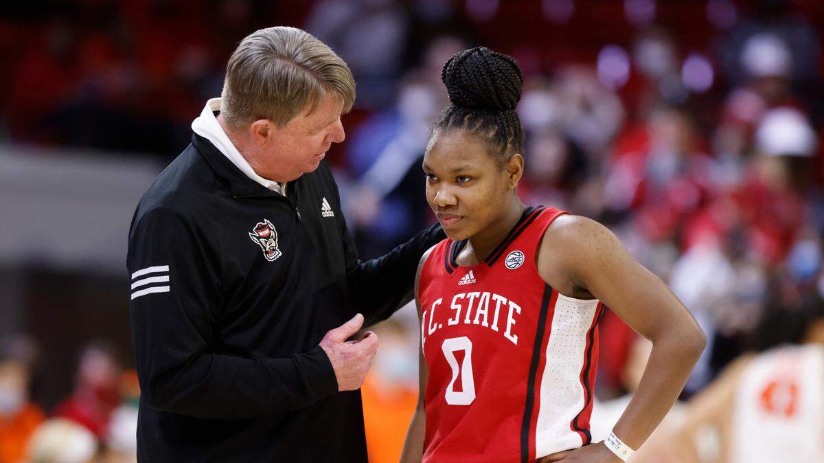 N.C. State head coach Wes Moore talks with Diamond Johnson (0) during the second half of N.C. State’s 95-53 victory over Syracuse at Reynolds Coliseum in Raleigh, N.C., Sunday, Feb. 20, 2022.
