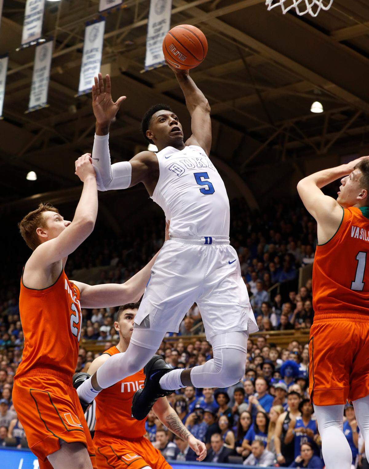 Duke’s RJ Barrett (5) heads to slam in two past Miami’s Sam Waardenburg (21) and Miami’s Dejan Vasiljevic (1) during the first half of Duke’s game against Miami at Cameron Indoor Stadium in Durham, N.C., Saturday, March 2, 2019.