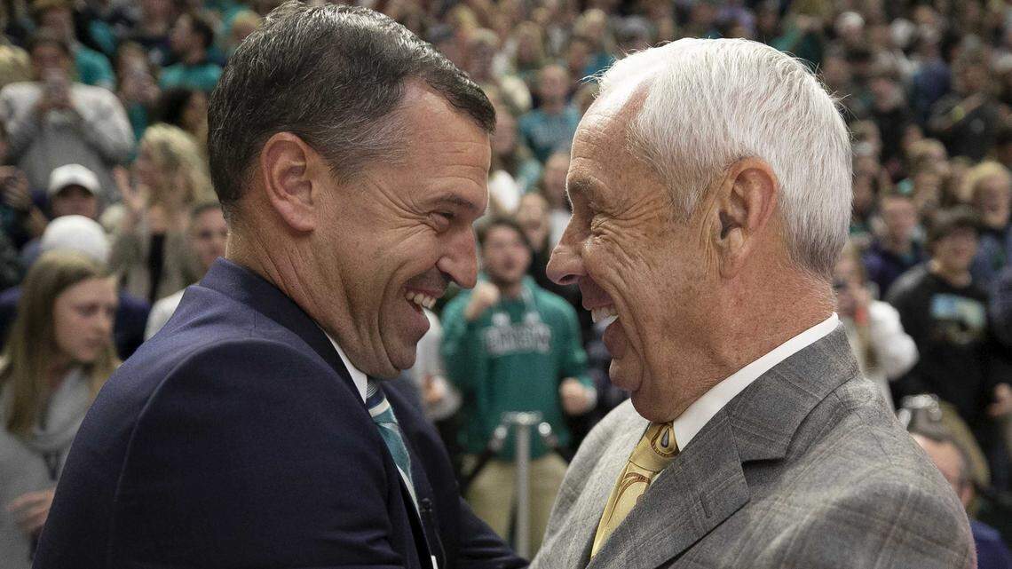 North Carolina coach Roy Williams embraces UNC-Wilmington coach C.B. McGrath prior to their game on Friday, November 8, 2019 at Trask Coliseum in Wilmington, N.C. McGrath was a long time assistant for Williams before taking the head coaching job in Wilmington.