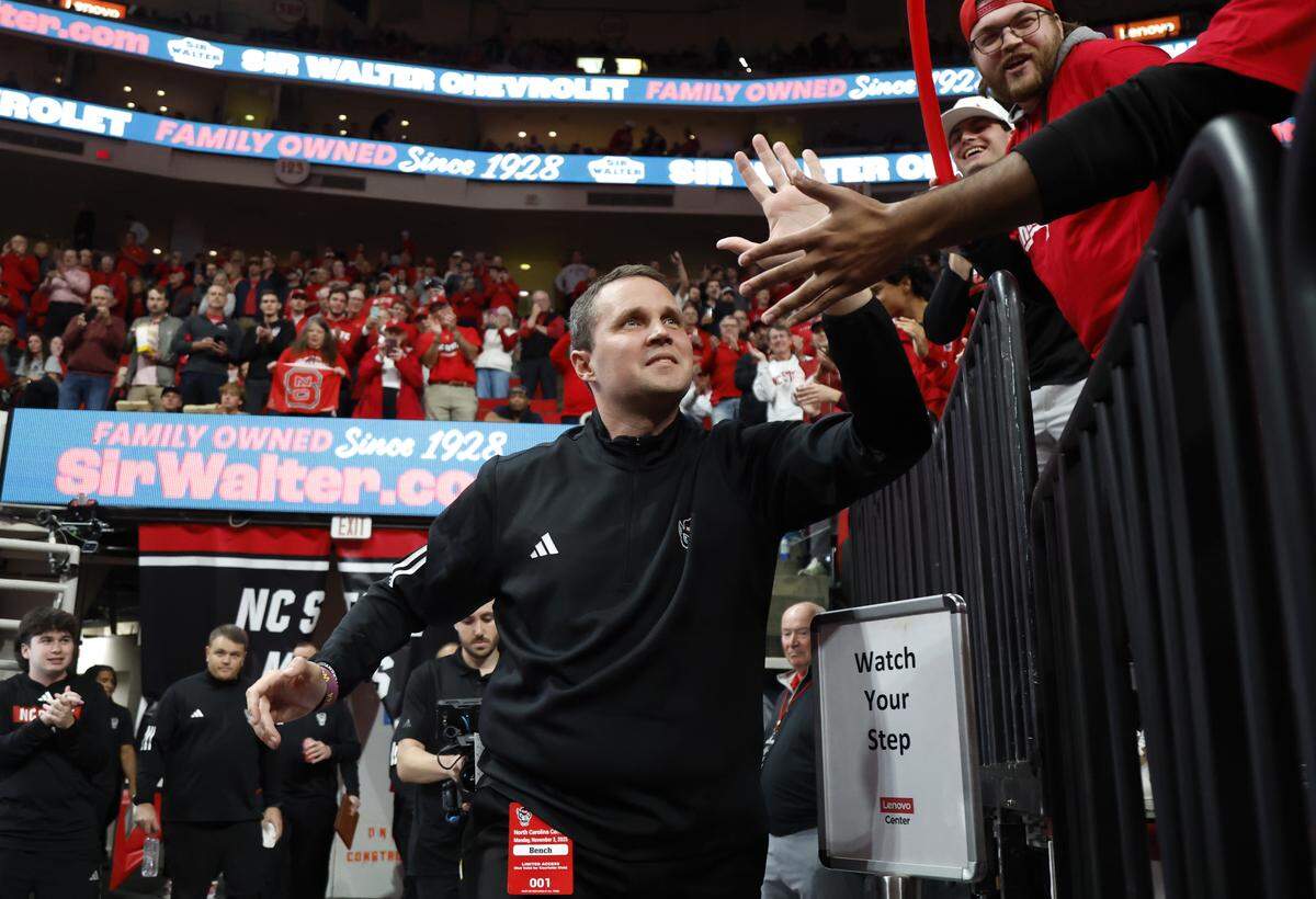 N.C. State head coach Will Wade greets the fans as he comes onto the court before N.C. State’s game against N.C. Central University at the Lenovo Center in Raleigh, N.C., Monday, Nov. 3, 2025.