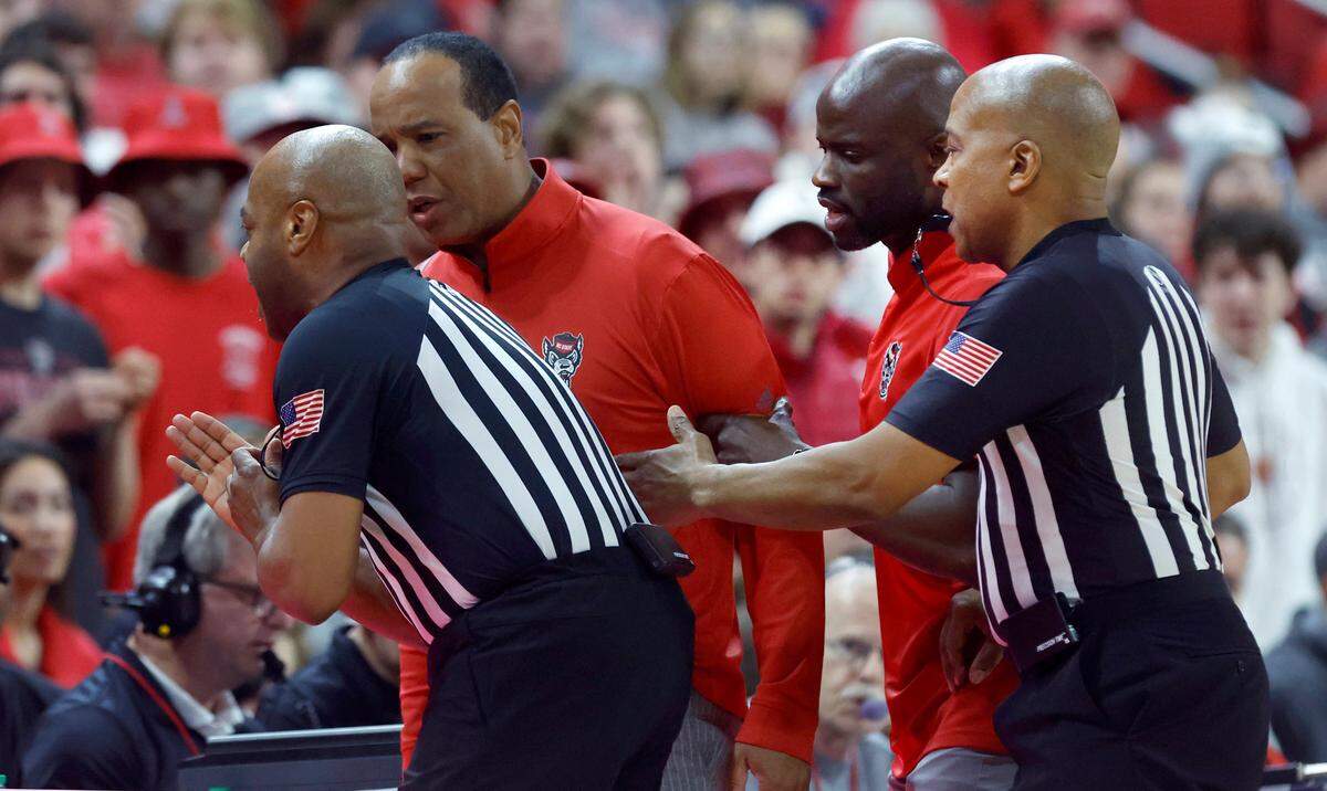 N.C. State head coach Kevin Keatts is held back after he was called for a technical during the first half of N.C. State’s game against Clemson at PNC Arena in Raleigh, N.C., Saturday, Feb. 25, 2023.