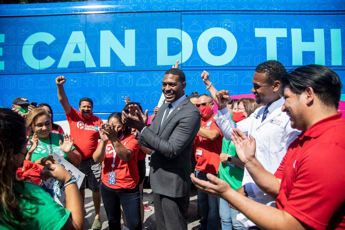 EPA Administrator Michael Regan, center, and White House policy advisor Dr. Cameron Webb, second from right, kick off a canvass event to boost vaccinations in low-vaccinated neighborhoods with community health worker volunteers Tuesday, June 16, 2021 at WakeMed in Raleigh.
