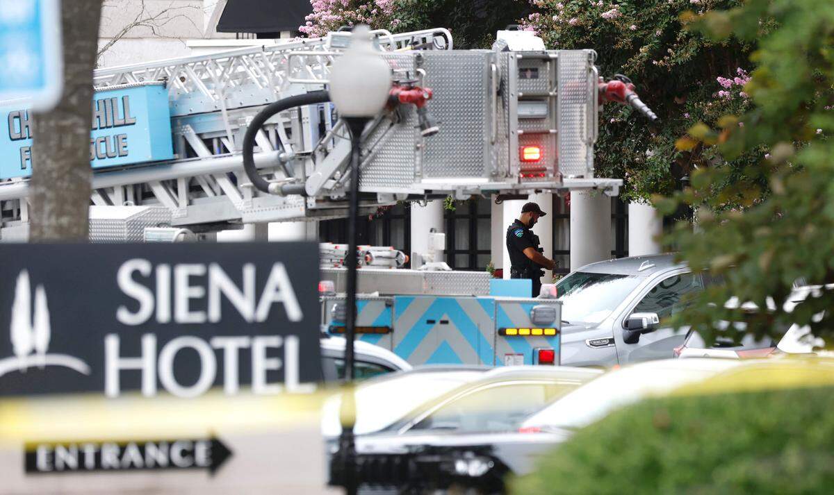 Police and fire personnel are stationed outside the Siena Hotel on East Franklin Street in Chapel Hill, N.C., Friday morning, August 22, 2025.