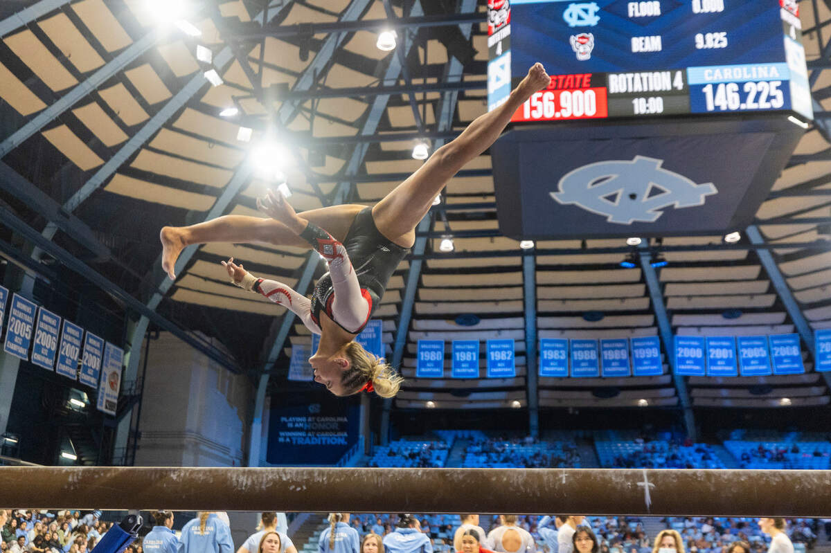 N.C.State’s Macy Jennings competes on the beam during a meet against UNC-Chapel Hill on Jan. 19, 2024, in Chapel Hill, N.C. The Wolfpack beat the Tar Heels, 196.225-195.325.
