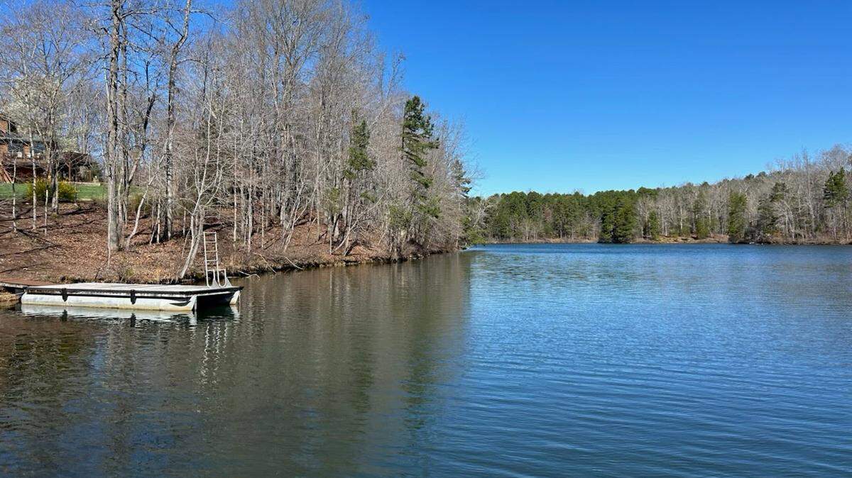 A repurposed pontoon boat serves as a platform on Mayo Lake in North Carolina’s Person County. New shoreline enforcement from Duke Energy has enraged some who live on the man-made body of water.