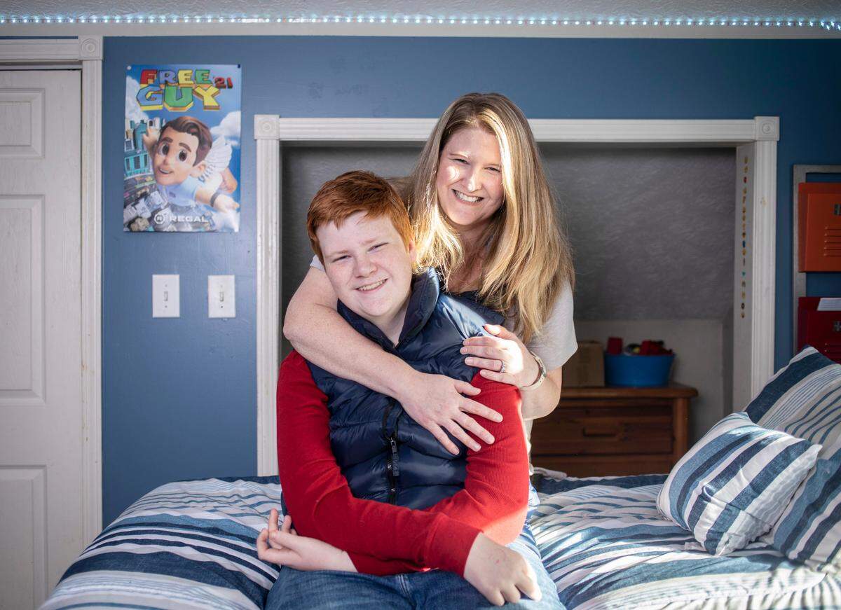 Quinn Wilson, 13, and his mother Lindsay Wilson pose for a portrait in Quinn’s room at their Newland, N.C. home on Monday, Nov. 29, 2021.