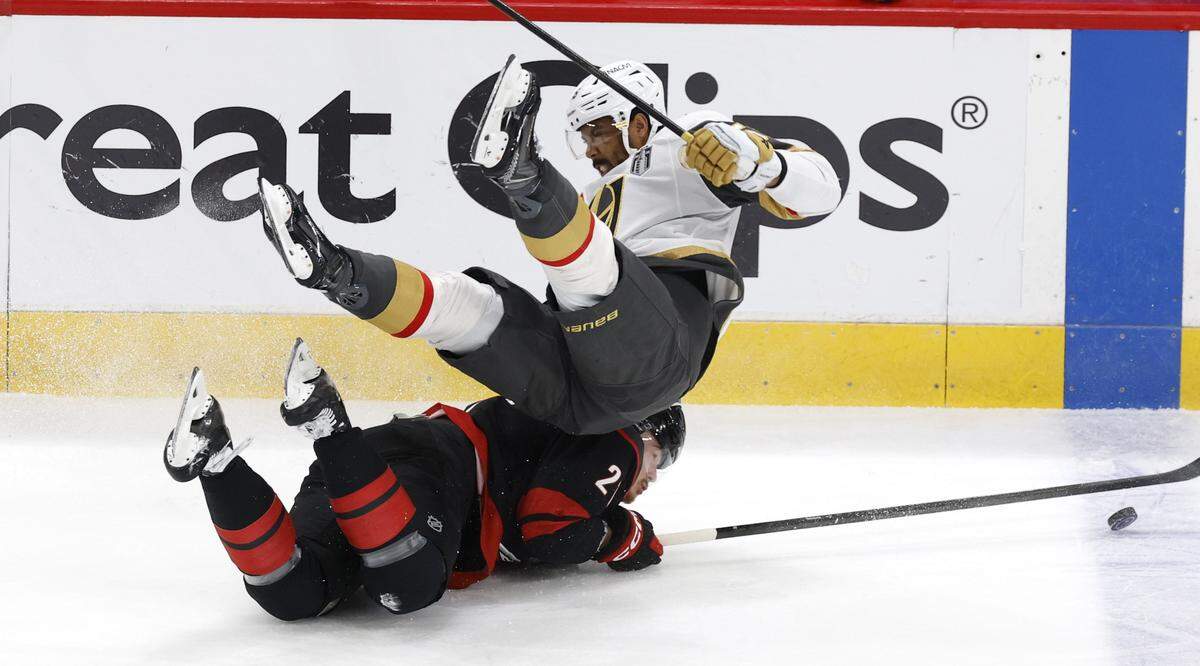 Vegas’ Keegan Kolesar (55) goes over Carolina's Alexander Nikishin (21) in the first period of the Hurricanes’ game against the Golden Knights in the second game of the Stanley Cup Final at the Lenovo Center in Raleigh, N.C., Thursday, June 4, 2026.