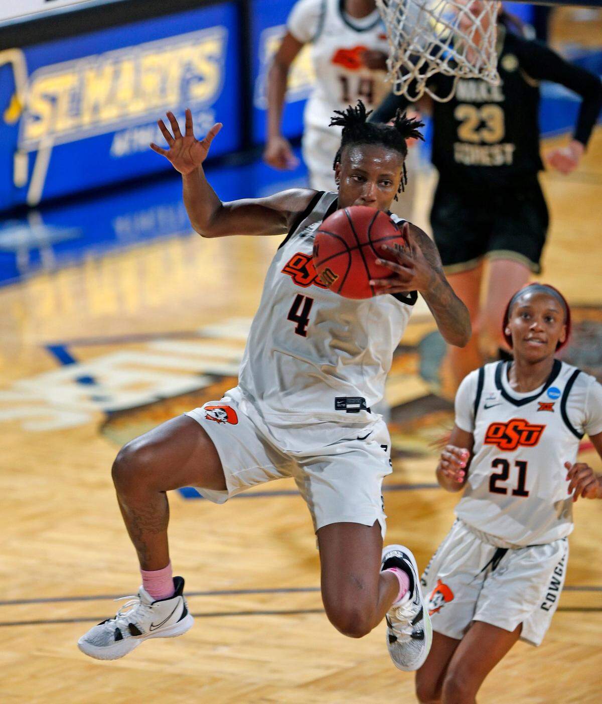 Oklahoma State forward Natasha Mack(4) leaps to make a save during the second half of a college basketball game in the first round of the women’s NCAA tournament at the Greehey Arena in San Antonio, Texas, Sunday, March 21, 2021. 