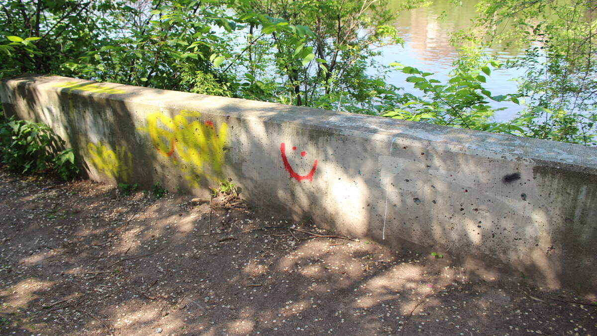 Smiley-face graffiti found near the site where a body was thrown into a river in Minneapolis. Oxygen’s “Smiley Face Killer: The Hunt for Justice” premieres on Jan. 19.