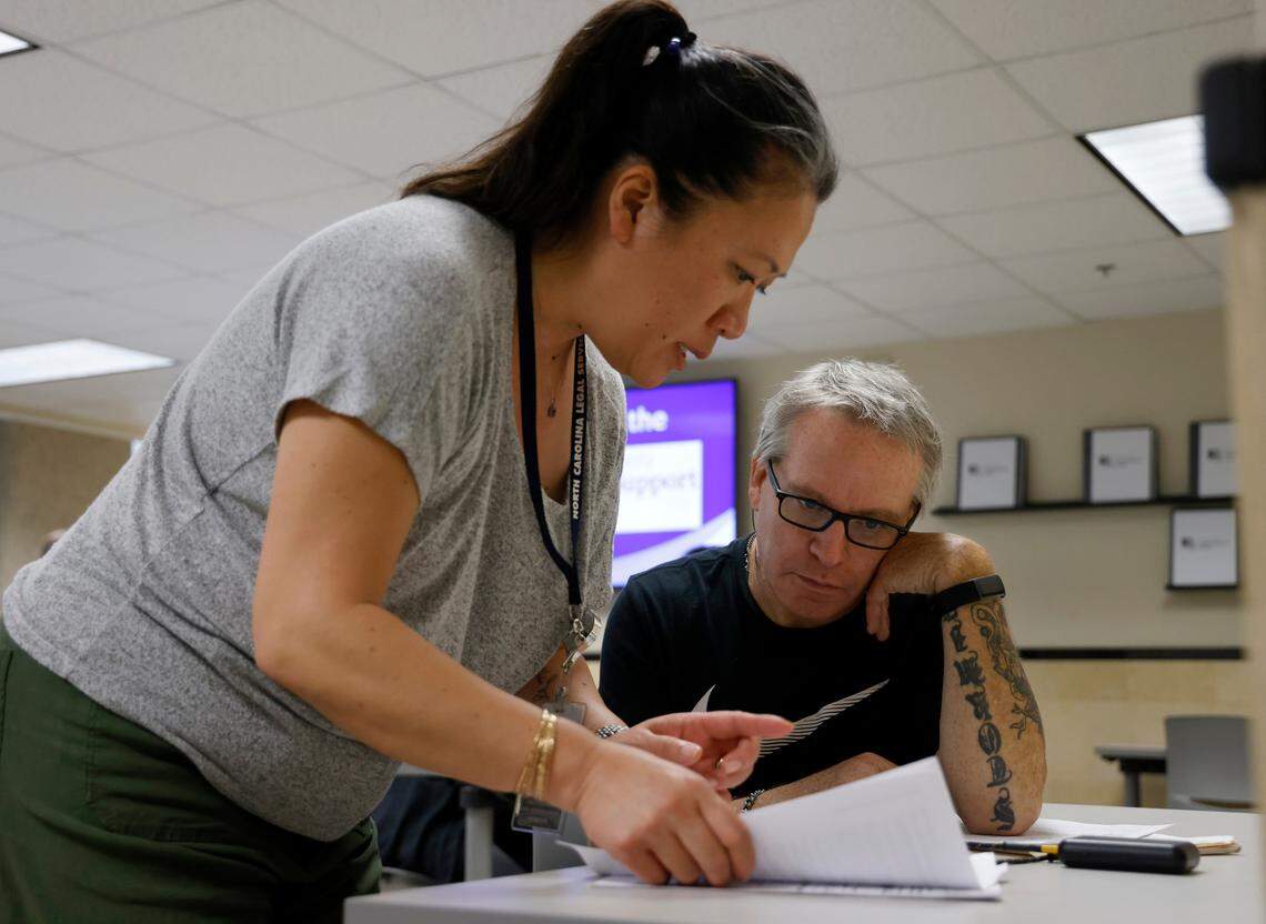 Anh LyJordan speaks with Scott Tingle at the Wake County Legal Support Center on Tuesday, May 16, 2023, in Raleigh, N.C.