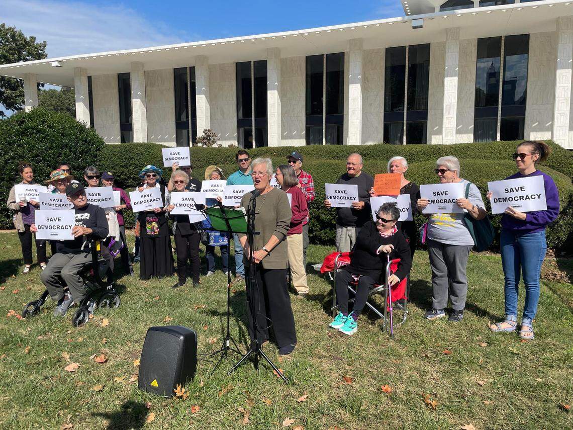 Karen Ziegler, a protester with Democracy Out Loud, speaks out against Republicans’ plan to override five vetoes from Democratic Gov. Roy Cooper. 