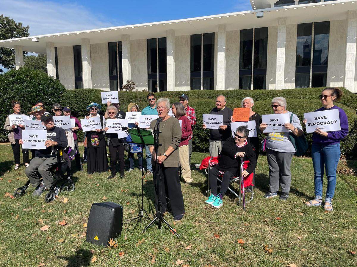 Karen Ziegler, a protester with Democracy Out Loud, speaks out against Republicans’ plan to override five vetoes from Democratic Gov. Roy Cooper. 