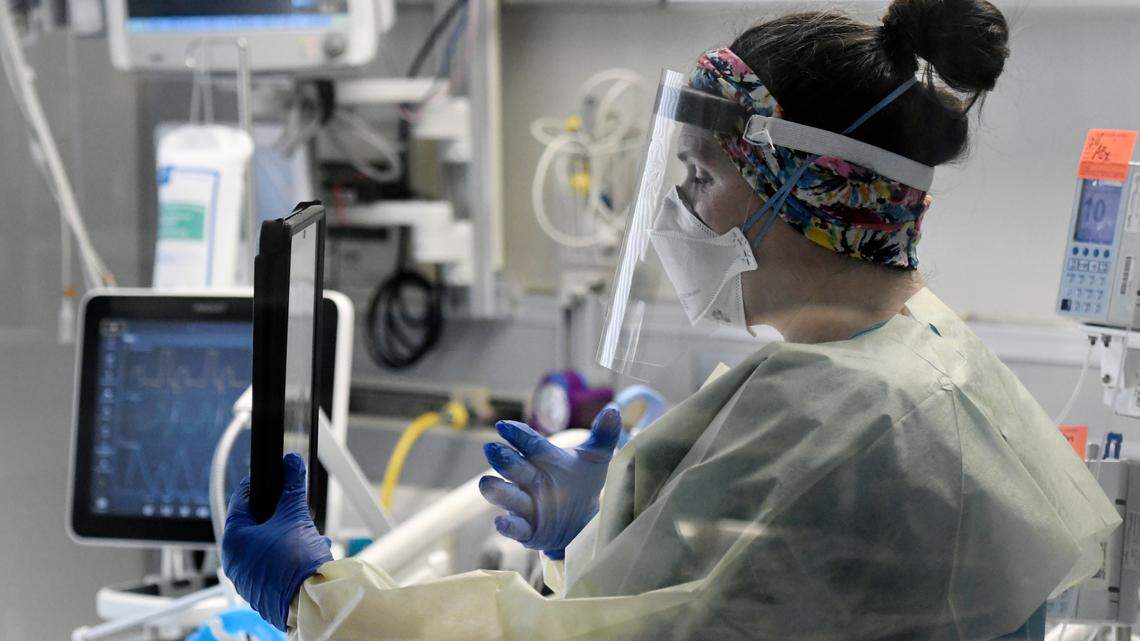 Shannon Costello, a palliative care nurse at UNC Rex hospital, talks with a COVID patient’s family via video FaceTime on a tablet in March 2021.