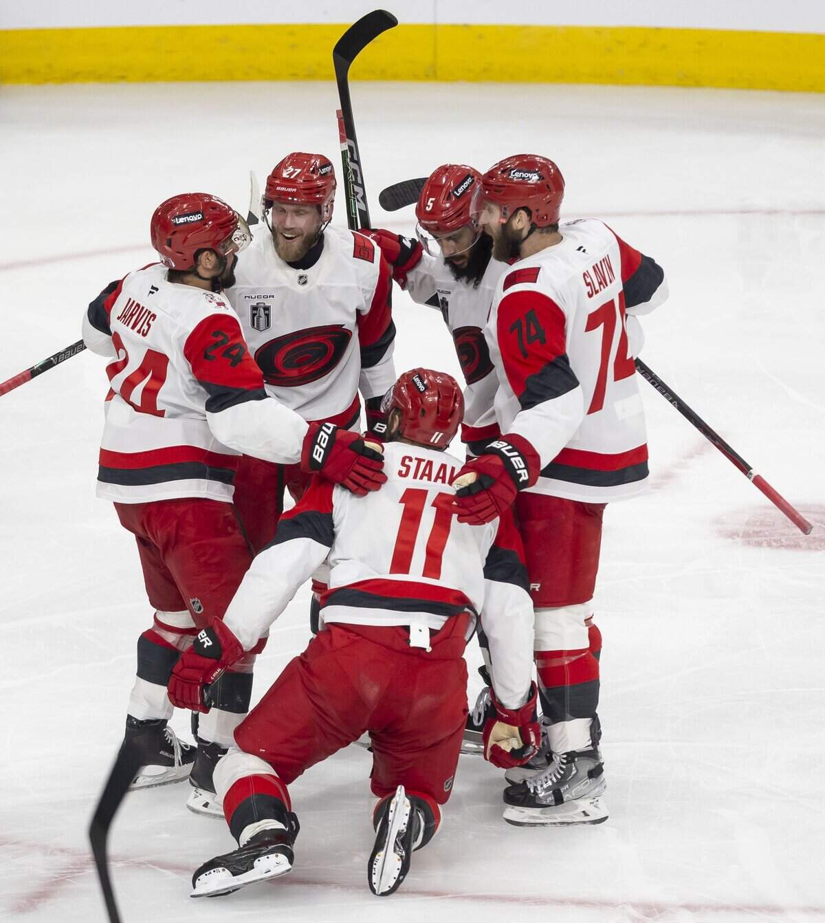 Carolina Hurricanes players Seth Jarvis (24), Nikolaj Ehlers  (27), Jacoob Slavin (74) and Jalen Chatfield (5) surround center Jordan Staal (11) after he scored to take 4-3 lead over Vegas in the third period of Game 4 of the Stanley Cup Final, on Tuesday, June 9, 2026 in Las Vegas, NV.