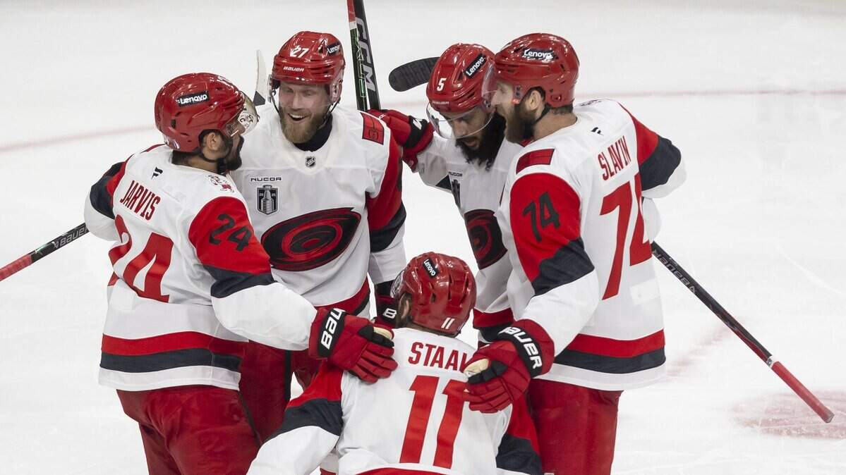 Carolina Hurricanes players Seth Jarvis (24), Nikolaj Ehlers  (27), Jacoob Slavin (74) and Jalen Chatfield (5) surround center Jordan Staal (11) after he scored to take 4-3 lead over Vegas in the third period of Game 4 of the Stanley Cup Final, on Tuesday, June 9, 2026 in Las Vegas, NV.