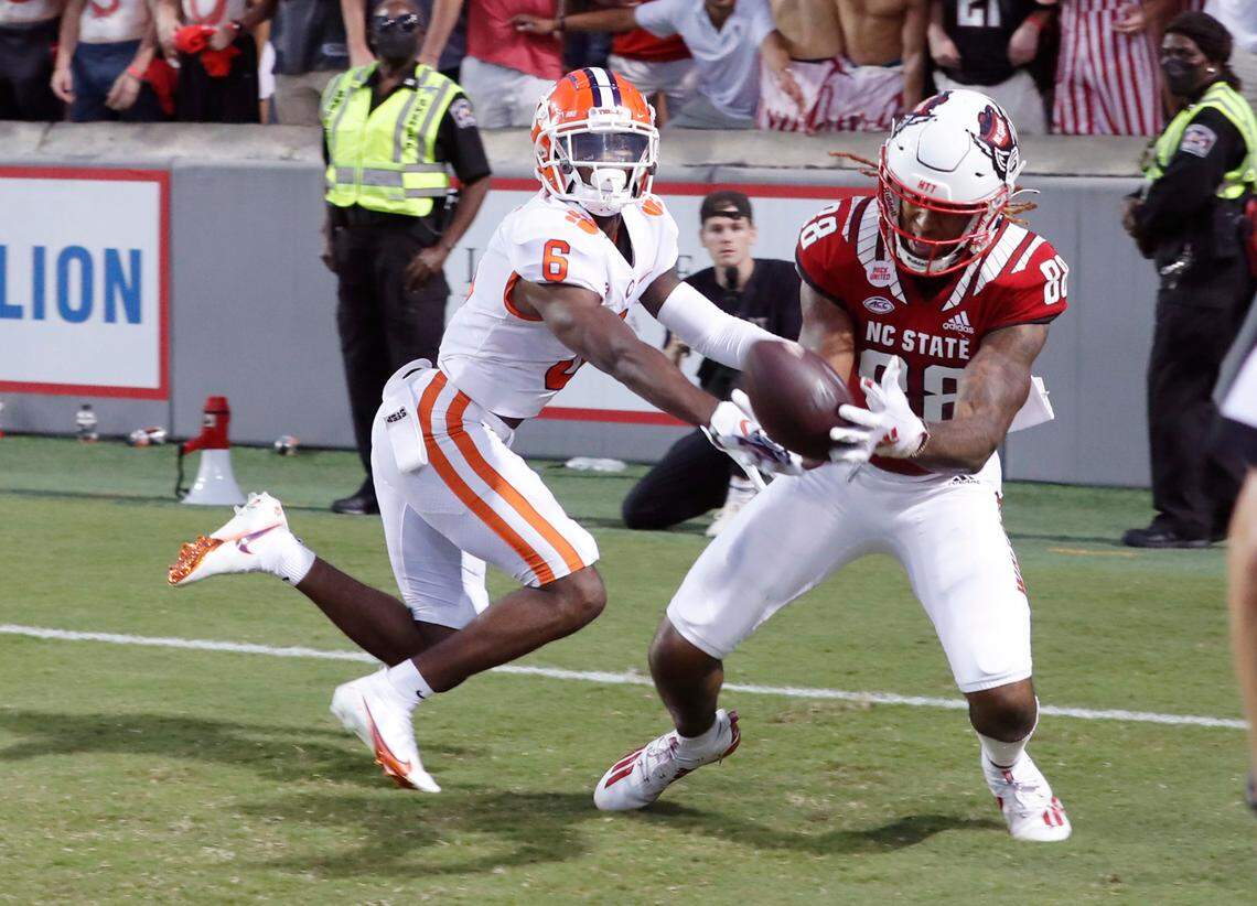 N.C. State wide receiver Devin Carter (88) makes the 22-yard touchdown reception in the second overtime as Clemson cornerback Sheridan Jones (6) defends during N.C. State’s 27-21 overtime victory over Clemson at Carter-Finley Stadium in Raleigh, N.C., Saturday, Sept. 25, 2021.