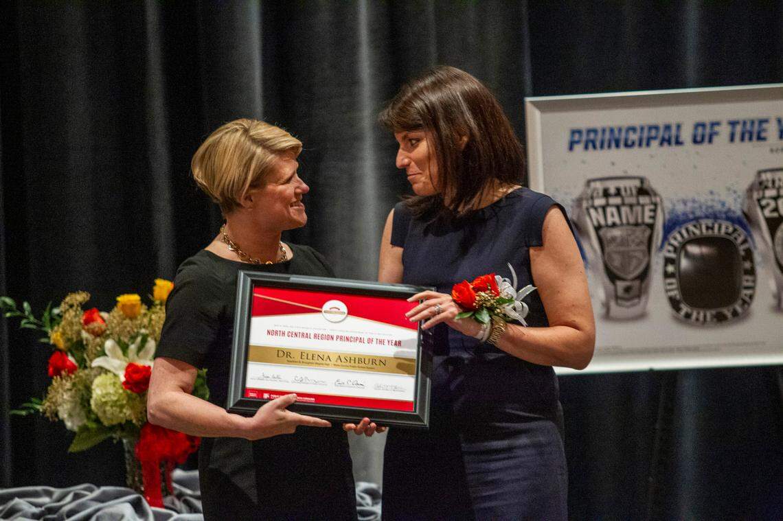 Elena Ashburn, the principal of Broughton High School in Raleigh, right, accepts an award from Superintendent of Public Instruction of North Carolina Catherine Truitt before Ashburn was named the 2021 Wells Fargo North Carolina Principal of the Year during a banquet at the Umstead Hotel and Spa in Cary Friday, May 21, 2021.