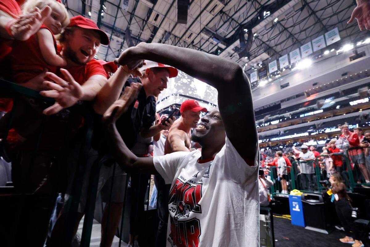 N.C. State’s Mohamed Diarra (23) greets fans as he walks off the court after the Wolfpack’s 76-64 victory over Duke in their NCAA Tournament Elite Eight matchup at the American Airlines Center in Dallas, Texas, Sunday, March 31, 2024.
