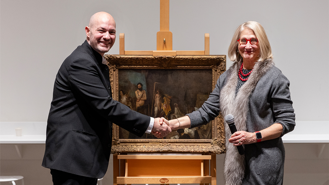 Raphaël Falk, great-nephew of Armand Isaac Dorville, with Ackland Art Museum Director Katie Ziglar during a ceremony where the museum gave back “The Studio of Thomas Couture.” Nazis sold the painting at an auction of Dorville’s collection in 1942 and kept the proceeds. UNC acquired the painting 30 years later.