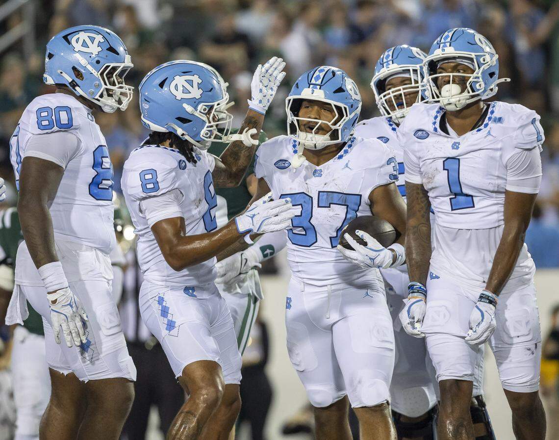North Carolina running back Davion Gause (37) is surrounded by teammates after scoring a touchdown on a 12-yard run in the second quarter to give the Tar Heels a 17-3 lead against UNC Charlotte on Saturday, September 6, 2025 at Jerry Richardson Stadium in Charlotte, N.C. 