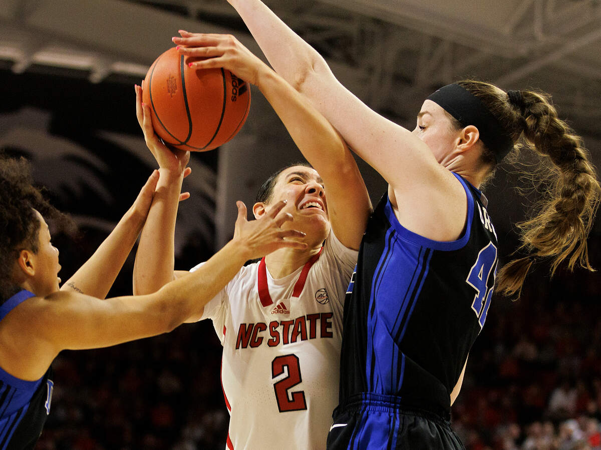 N.C. State’s Mimi Collins is fouled while driving to the basket against Duke’s Taina Mair and Kennedy Brown during the second half of the Wolfpack’s 72-57 win on Sunday, Jan. 21, 2024, at Reynolds Coliseum in Raleigh, N.C.