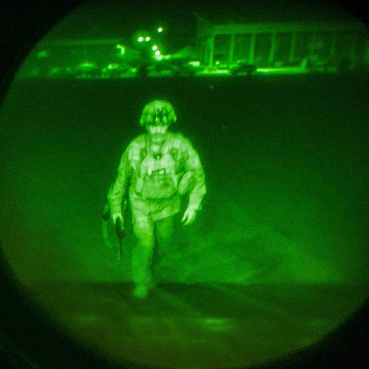 Major General Chris Donahue, commander of the U.S. Army 82nd Airborne Division, 18th Airborne Corps, boards a C-17 cargo plane at the Hamid Karzai International Airport in Kabul, Afghanistan. Maj. Gen. Donahue is the final American service member to depart Afghanistan. The image was made through a night vision scope and provided by U.S. Central Command.