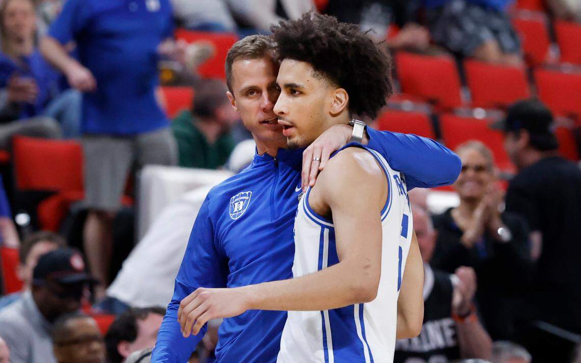 Duke head coach Jon Scheyer congratulates Tyrese Proctor (5) as he comes off the floor late in the second half of Duke’s 89-66 victory over Baylor in the second round of the 2025 NCAA men’s basketball championship at the Lenovo Center in Raleigh, N.C., Sunday, March 23, 2025.