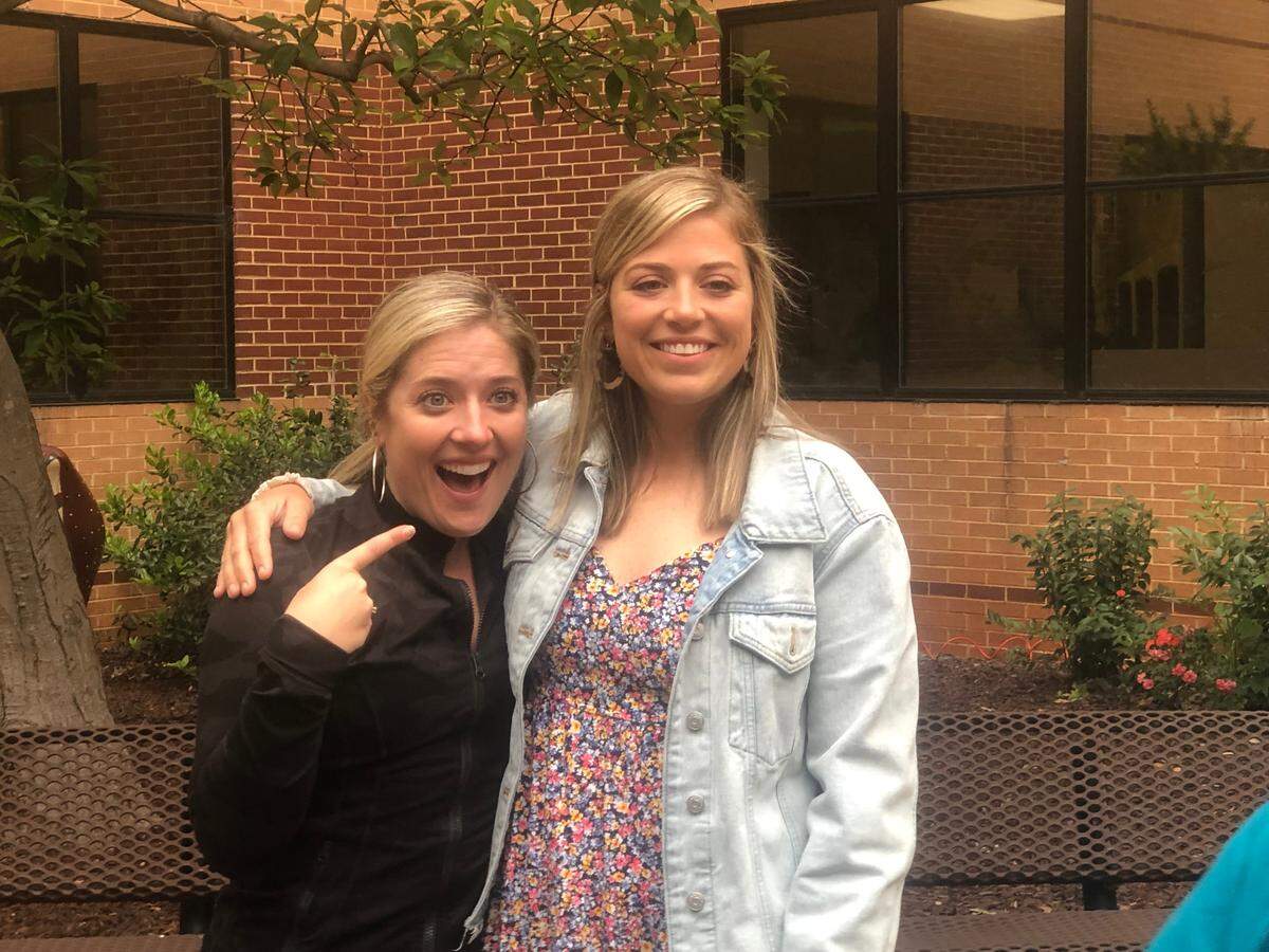 Betsy Graves, dance director at Broughton High School, points a finger at special-education teacher Caroline Olson, who was honored at the Raleigh, N.C. school on May 12, 2022 for being named the Wake County 2022-23 Teacher of the Year. Graves was the 2017-18 Wake Teacher of the Year.