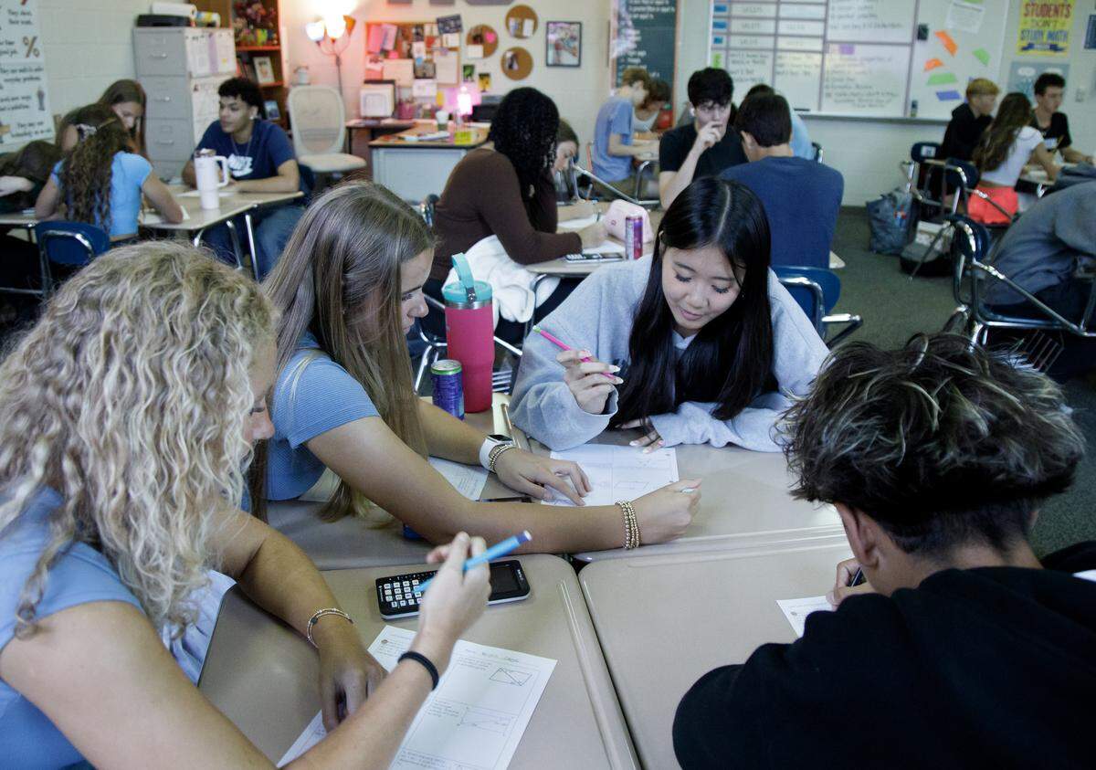 Millbrook High School sophomore Lana Nguyen, center, works with classmates on an assignment during a math class on Tuesday, Sept. 2, 2025, in Raleigh, N.C.