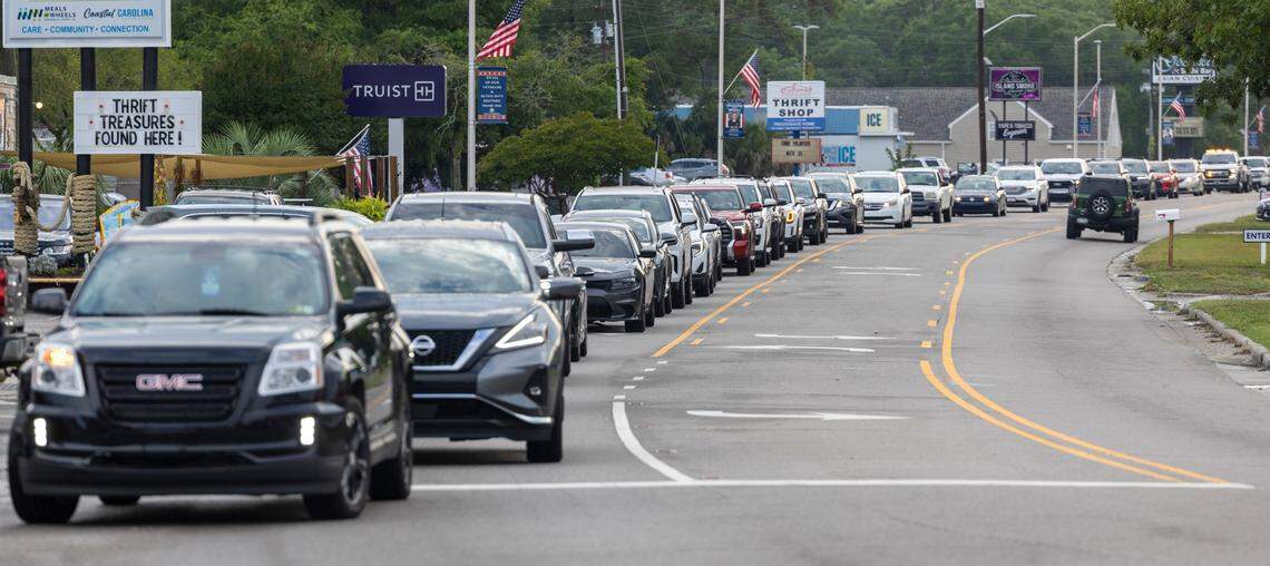 Traffic backs up on Beach Dr. to make the right turn on to River Road on Thursday, June 27, 2024 as visitors flock to the seafood restaurants in Calabash, N.C.