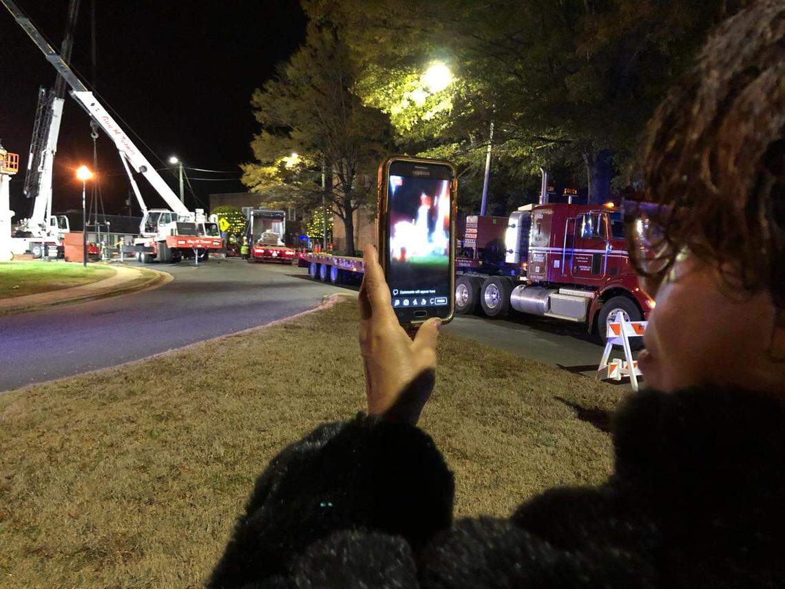 Sandra Day of Moncure watches at the Confederate monument in downtown Pittsboro is readied to be removed.