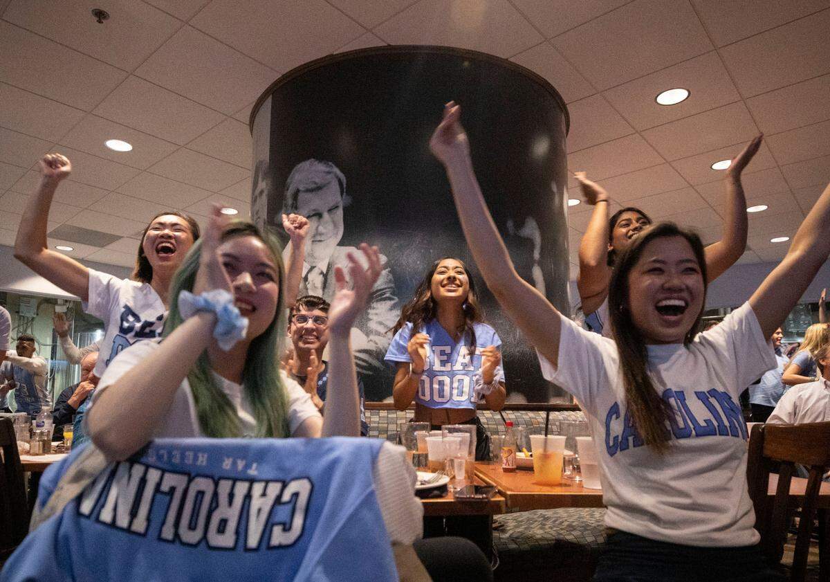 Tar Heel fans watching the historic Final Four match up against Duke at Top of the Hill in Chapel Hill, N.C. cheer after their team scored in the second half on Saturday, April 2, 2022.