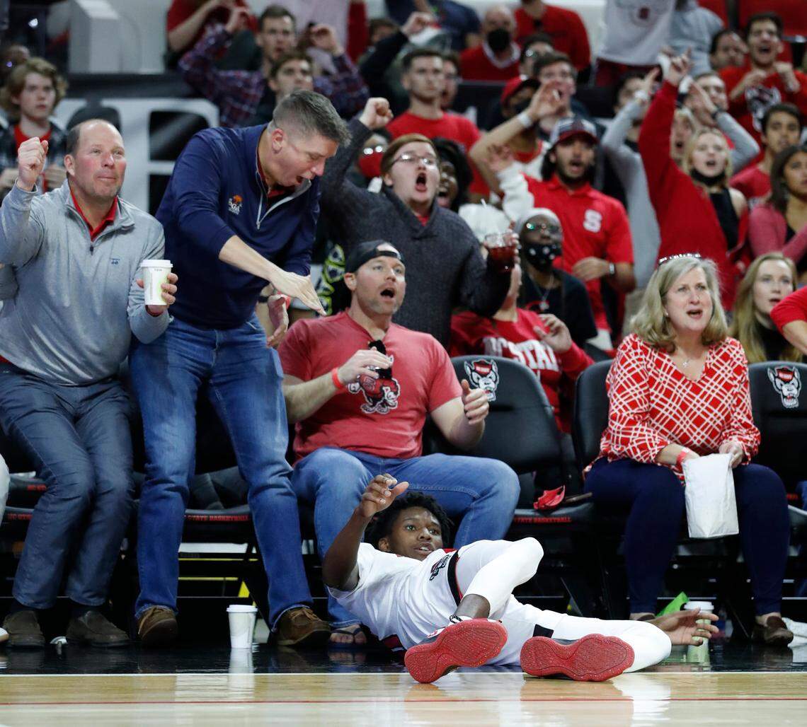 N.C. State’s Terquavion Smith (0) watches as his three-pointer goes in after being fouled during the second half of Louisville’s 73-68 victory over N.C. State at PNC Arena in Raleigh, N.C., Saturday Dec. 4, 2021.