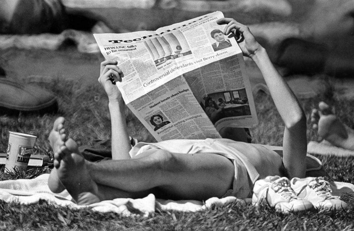 A student reads the Technician on NC State’s campus in April 1978.