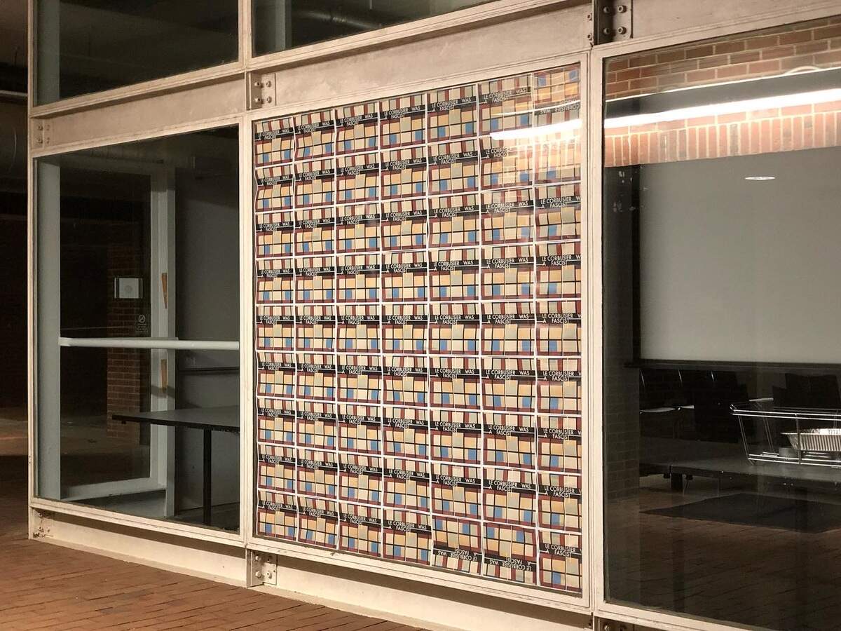 Posters displayed on the entrance to the Allred Gallery at the NC State College of Design as part of a protest against the school’s use of Le Corbusier as inspiration.