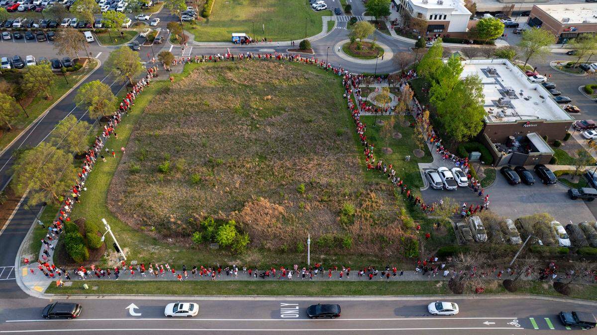 Hundreds of NC State fans wait outside the Triangle Town Center Applebee’s in Raleigh on Tuesday, April 2, 2024 hoping to get autographs from DJ Horne and DJ Burns Jr. ahead of the Wolfpack’s Final Four game on Saturday.