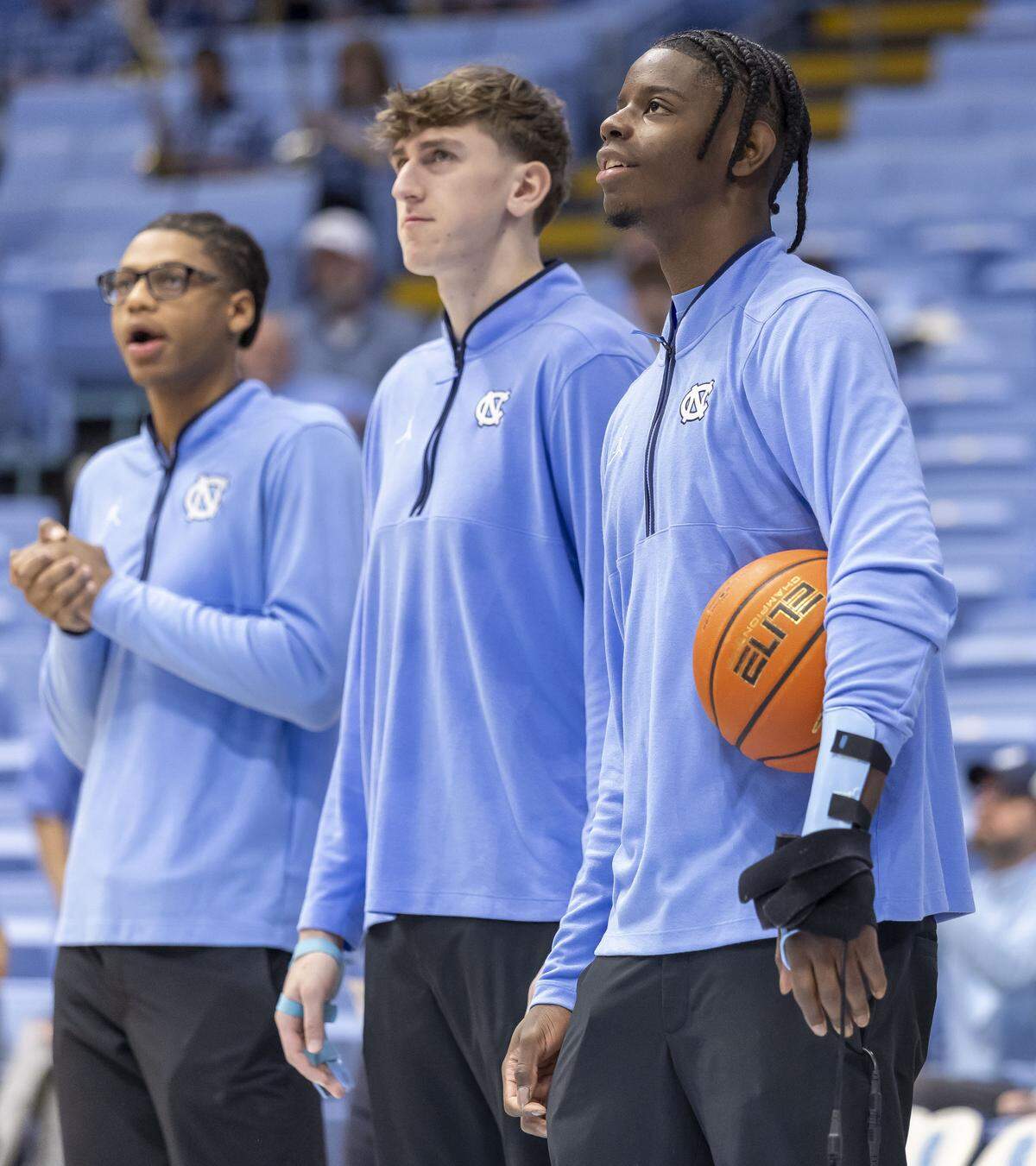 North Carolina forward Caleb Wilson (8) watches his teammates warm up for their game against Pitt on Saturday, February 14, 2026 at the Smith Center in Chapel Hill, N.C. Wilson is sidelined after fracturing his left hand in the game against Miami. 