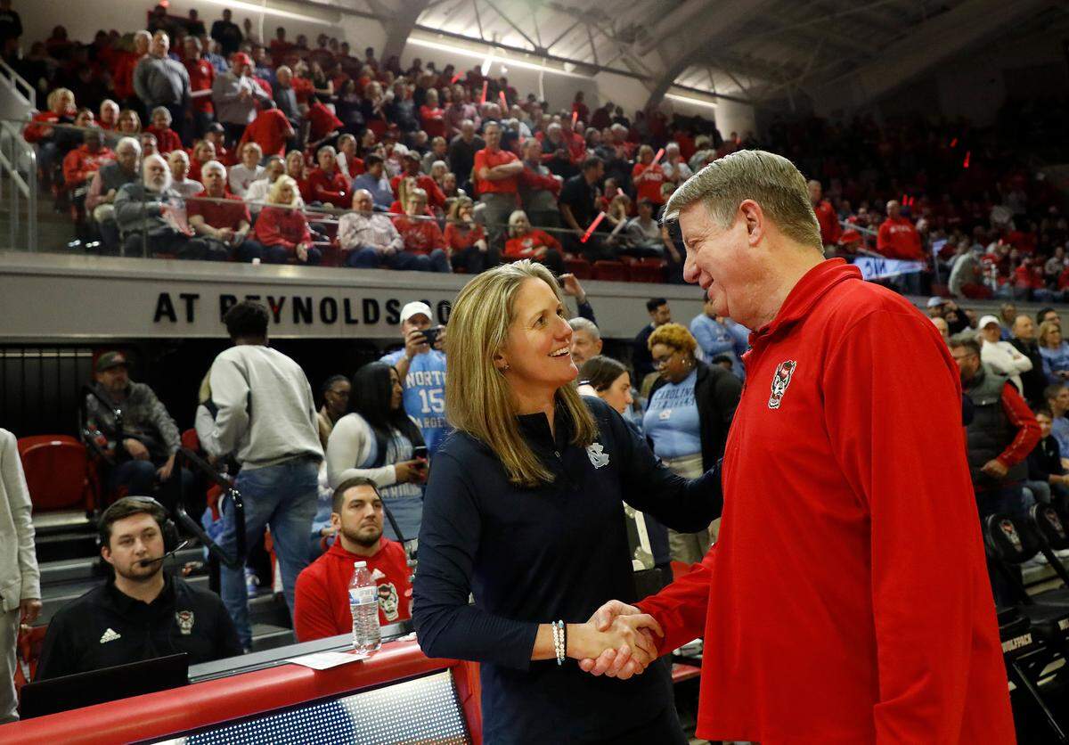 North Carolina head coach Courtney Banghart and N.C. State head coach Wes Moore share a word before their teams face off on Thursday, Feb. 1, 2024, at Reynolds Coliseum in Raleigh, N.C.