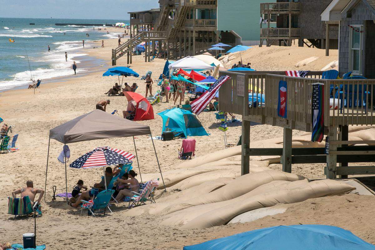The beach front between the Cape Hatteras Motel and the Outer Bank Motel on Wednesday, June 30, 2021 in Frisco, N.C. This area is one of the hot spots along NC 12 that is subjected to flooding and erosion during storms. Large sandbags have been placed here to protect the buildings along the oceanfront.