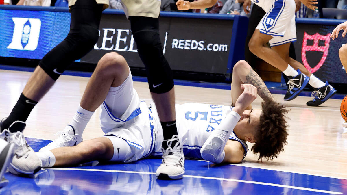 Duke’s Tyrese Proctor (5) holds his heads after he was injured during a fall in the first half of Duke’s game against Wake Forest at Cameron Indoor Stadium in Durham, N.C., Monday, Feb. 12, 2024.
