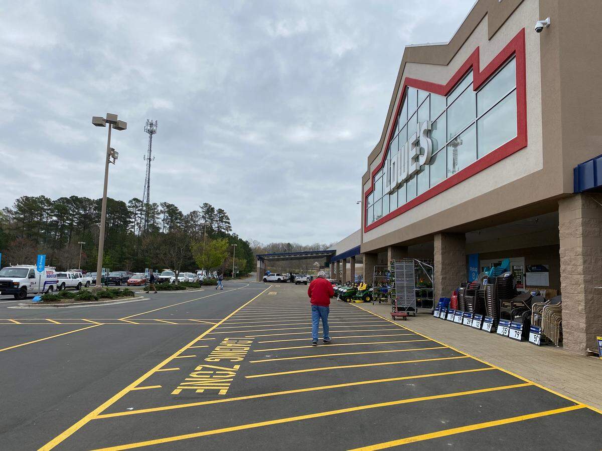 A customer walks into the Lowe’s Home Improvement store on Grove Barton Road in Raleigh, March 18, 2020.