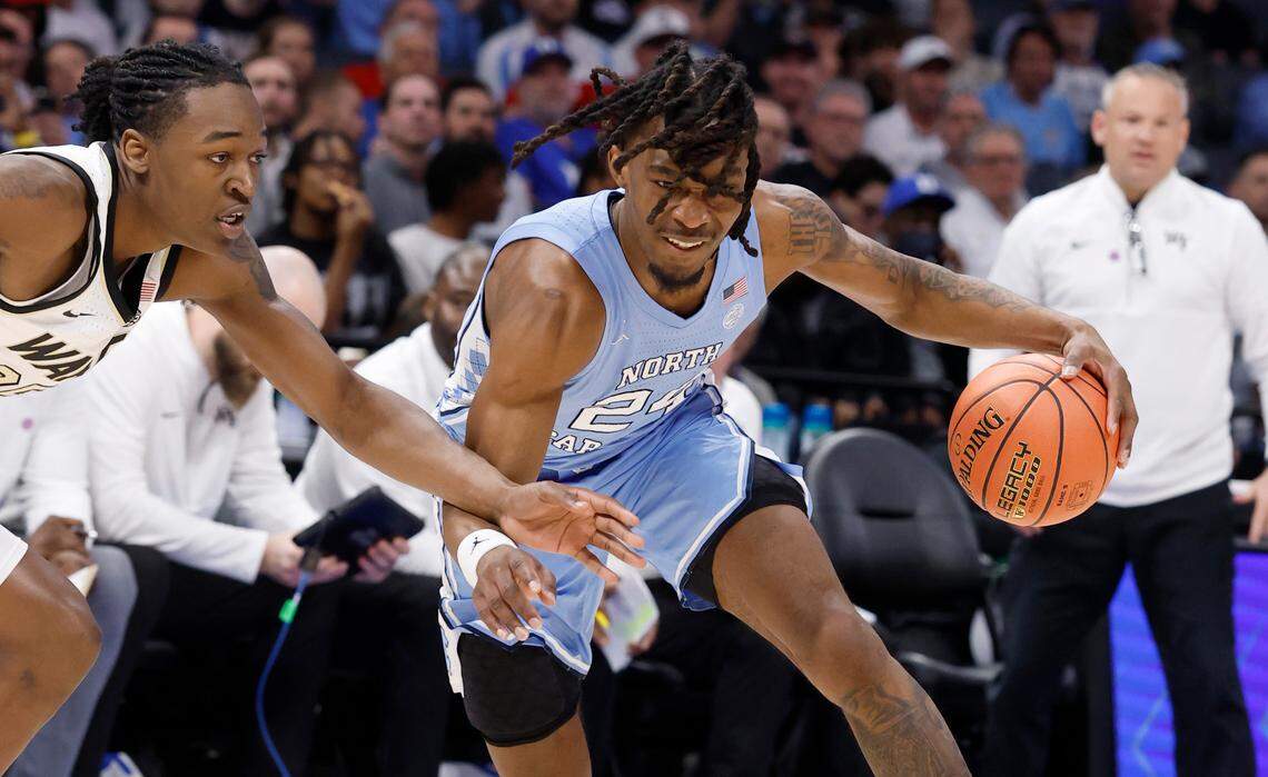 North Carolina’s Jae’Lyn Withers (24) drives past Wake Forest’s Tre’Von Spillers (25) during the first half of UNC’s game against Wake Forest in the quarterfinals of the 2025 ACC Men’s Basketball Tournament at the Spectrum Center in Charlotte, N.C., Thursday, March 13, 2025.
